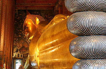 Fototapeta premium The 46 Meters Long Reclining Buddha Image of Wat Pho Temple Complex Located in Phra Nakhon District, Bangkok, Thailand
