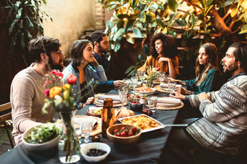 group of adult friends at dinner garden party together having dinner
