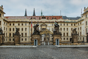 Fototapeta na wymiar Empty and closed Prague Castle,Czech Republic, during COVID-19 pandemic lockdown in January 2021.Main gate of Prague Castle with statues. No tourists,no guards.Famous travel destination