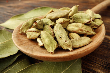 Сardamom spice bunch on wooden table macro