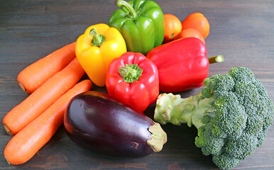 Colorful assorted fresh vegetables on black wooden background or the concept of EATING WELL