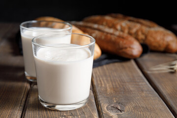 Kefir - trendy healthy food available providing powerful probiotics. Probiotic cold fermented dairy drink on wooden background. Rustic style. Probiotic food concept. Copy space, close up