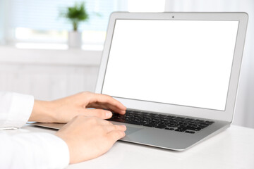 Woman working with modern laptop indoors, closeup. Space for design