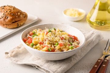 Italian salad with ditalini pasta, vegan sausage on white table. Close up. Tasty dinner.