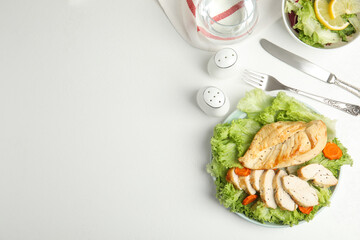 Tasty cooked chicken fillet with fresh salad  and space for text on white table, flat lay. Healthy meals from air fryer