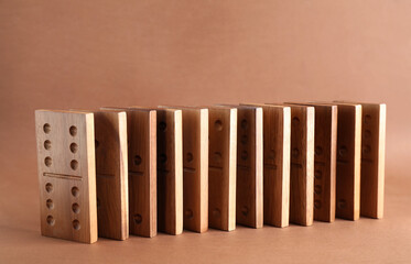 Wooden domino tiles with pips on brown background