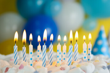 Birthday cake with burning candles on blurred background, closeup