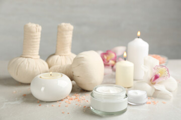 Fototapeta na wymiar Beautiful spa composition with skin care products and candles on marble table