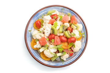 Vegetarian salad of cauliflower cabbage, kiwi, tomatoes, microgreen sprouts isolated on white background. Top view.