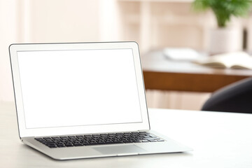 Fototapeta premium New modern laptop on white table in office. Space for text