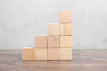 Ladder career path for business growth success process concept.Hand arranging wood block stacking as step stair with arrow up