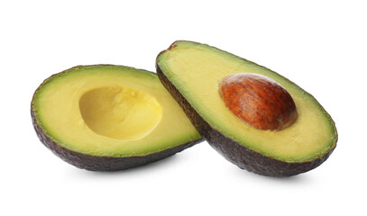 Cut ripe avocado with pit on white background