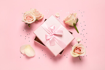 Elegant gift box, beautiful flowers and confetti on pink background, flat lay