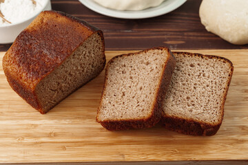 Sliced rye bread on brown wooden background