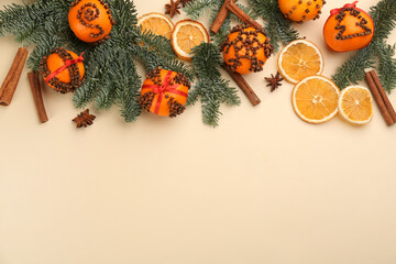 Flat lay composition with pomander balls made of fresh tangerines on beige background. Space for text