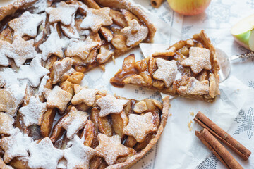 Traditional apple pie on the table with decorations.