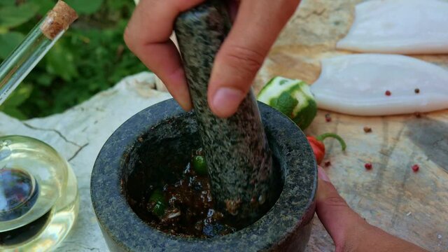 Grind the spices with a stone mortar.