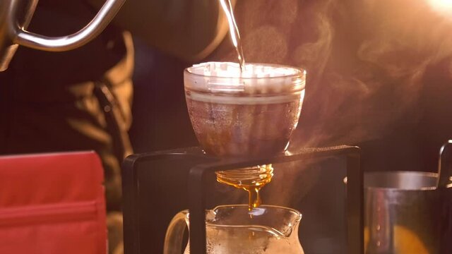 Brewing pour over filter coffee using gooseneck kettle in slow motion - plastic brewer