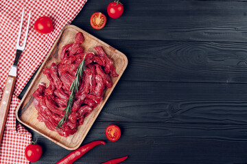 Raw beef meat fillet on wooden board