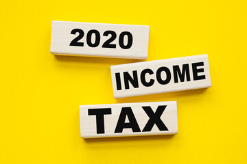 words INCOME TAX 2020 written on cubes . You can use in business, marketing and other concepts.