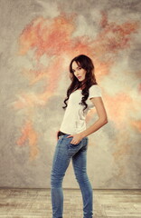 Brunette in blue jeans poses in the studio