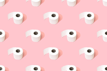 Rolls of toilet paper on a pink background pattern.