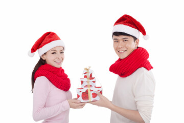 Portrait of young couple wearing Santa hats,holding gifts