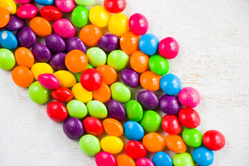 Fototapeta na wymiar Skittles candy on the table, colorful sweet candy background