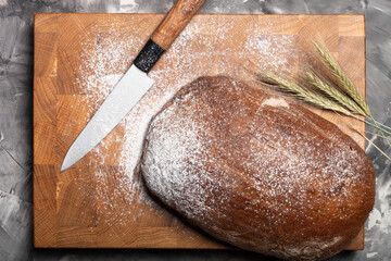 Composition with a bread on a textured plastered surface
