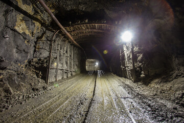 Naklejka premium Underground gold mine shaft tunnel drift with light