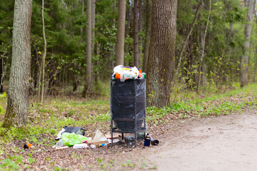 Garbage waste in park full of all sort of trash. Spring summer time. Save planet environment