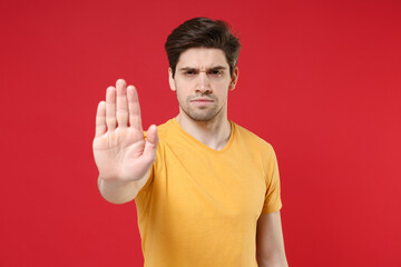 Young refusing serious strict protestive unshaved caucasian handsome man 20s wearing casual basic...