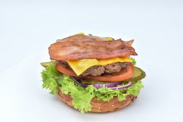 burger with melted cheese, ham, tomatoes and fried onions