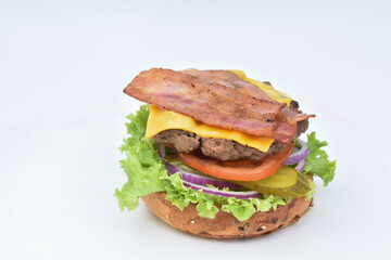 burger with melted cheese, ham, tomatoes and fried onions
