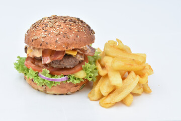 burger with melted cheese, ham, tomatoes and fried onions