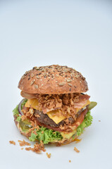 burger with melted cheese, ham, tomatoes and fried onions