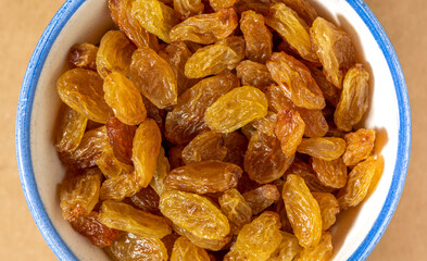 Raisins in bowl, close-up. Healthy food.