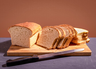 Toast bread slices and bread knife on cutting board. Copy space.