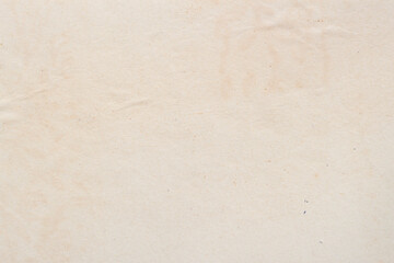 Texture of aged paper sheet, dirt stains, spots, wrinkle, creame beige color, vintage background