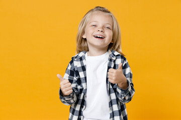 Little cute fun happy blond long-haired kid boy 5 years old wearing casual clothes posing isolated on bright yellow wall color background children studio portrait. People childhood lifestyle concept