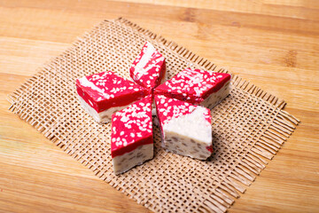 Hazelnut halva dessert with pomegranate juice on the wooden table.