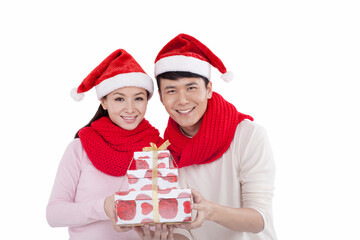 Portrait of young couple wearing Santa hats,holding gifts