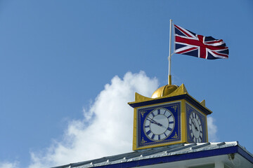 Close-up of the Union Jack flag on the clock of the entrance to the pier of Eastbourne, England,...