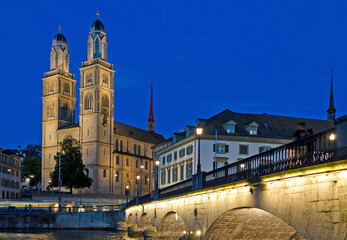 Iconic view of the Romanesque Grossmunster church in Zurich, Switzerland at night