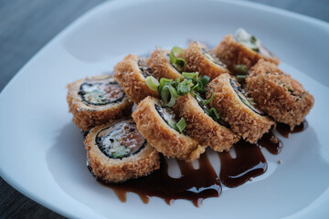 sushi roll plate with gray wooden background
