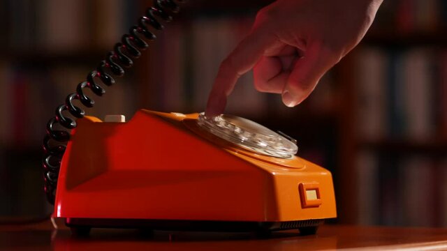 Making a phone call on an old rotary telephone