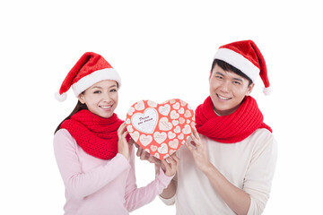 Portrait of young couple wearing Santa hats,holding gift