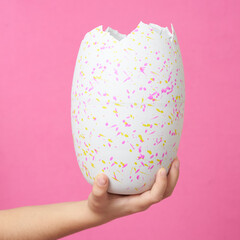 Hand holding broken egg, Easter concept, greeting card