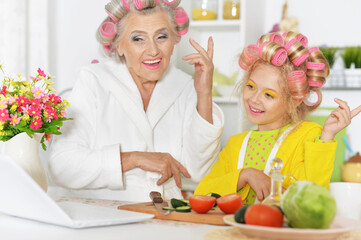 Senior woman and granddaughter at kitchen