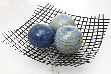 Three glass orbs on a wire mesh bowl looking like a neutron or proton made of three quarks